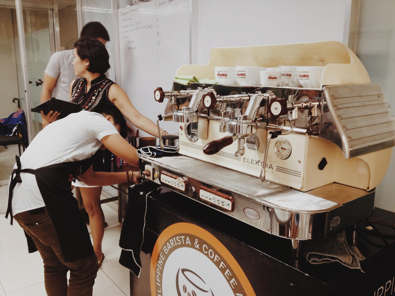 Barista using vintage coffee machine